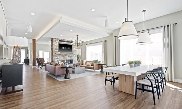 Dining room with elegant lighting and modern furnishings at Millyard at Meadow Commons Apartments