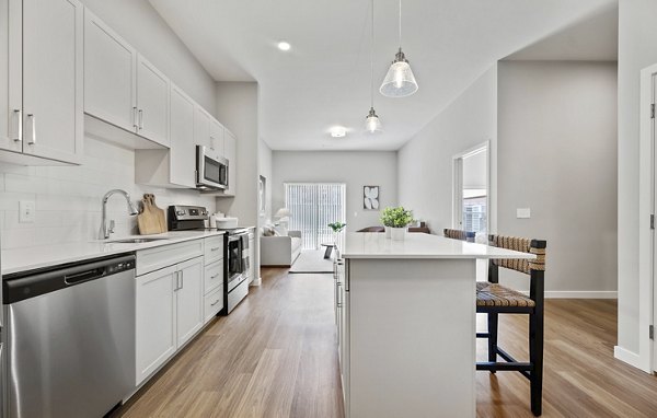 Modern kitchen with stainless steel appliances at Millyard at Meadow Commons Apartments