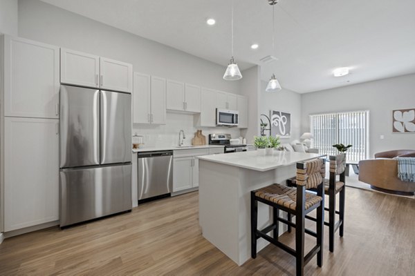 Modern kitchen with stainless steel appliances at Millyard at Meadow Commons Apartments