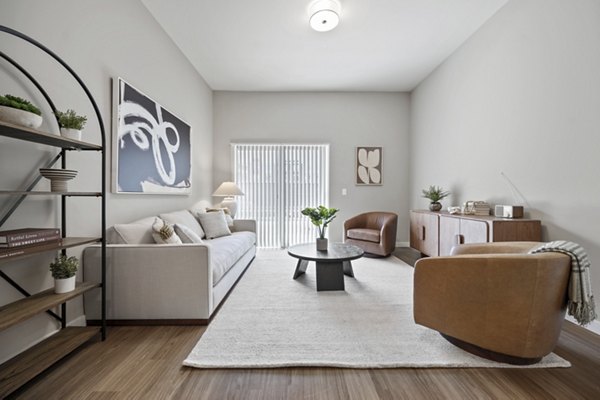 Spacious living room featuring modern decor at Millyard at Meadow Commons Apartments