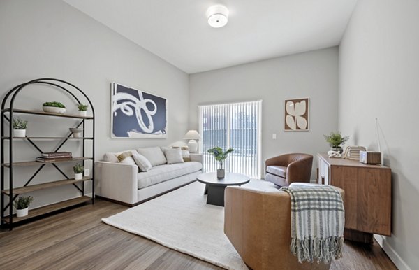 Living room with plush seating and modern decor at Millyard at Meadow Commons Apartments