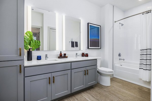 Modern bathroom with sleek fixtures and marble countertops at The Premier Apartments