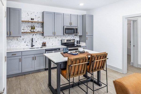 Modern kitchen with stainless steel appliances in The Premier Apartments