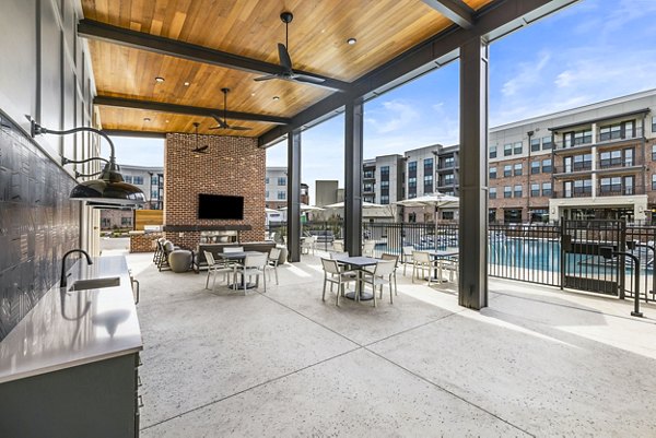 Grill area with modern patio at The Premier Apartments, offering a luxurious outdoor experience for residents
