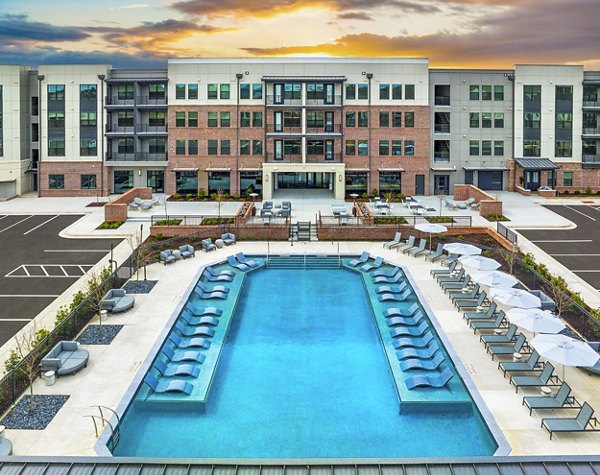 Luxury poolside with sun loungers at The Premier Apartments