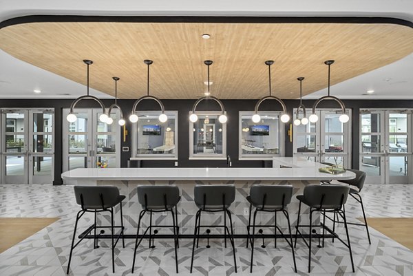Clubhouse with modern design and comfy seating at Mira Raleigh Apartments, a luxury apartment community