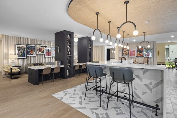 Modern clubhouse with cozy seating areas at Mira Raleigh Apartments, ideal for social gatherings and relaxation