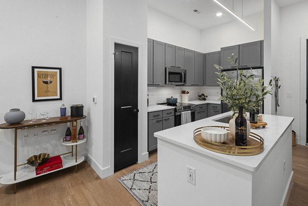 Kitchens with sleek countertops and stainless steel appliances at Mira Raleigh Apartments
