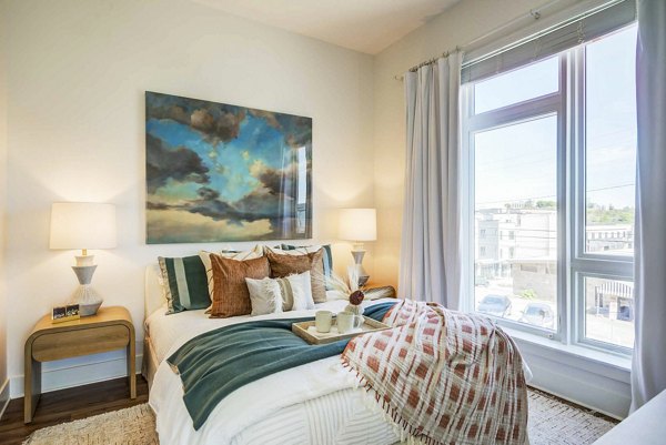 Cozy bedroom with modern decor and large windows at Queens Wedgewood Houston Apartments