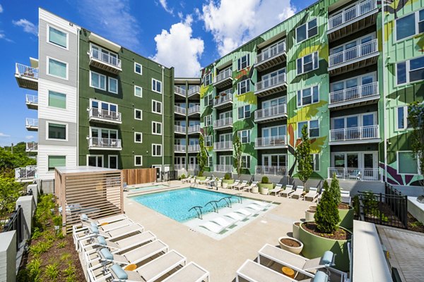 Relaxing outdoor pool at Queens Wedgewood Houston Apartments with chaise lounges