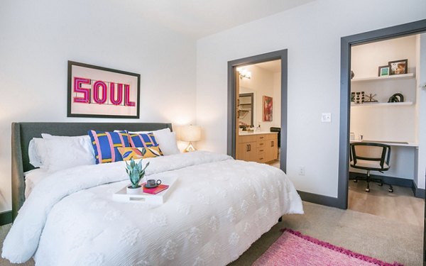 Bedroom with modern decor and elegant furnishings at The Sommery Apartments, a Greystar luxury property