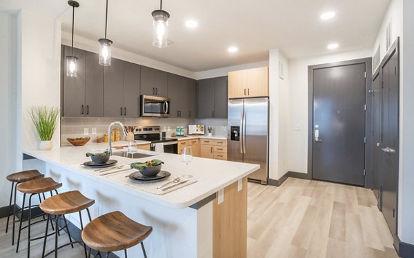 Spacious kitchen with modern appliances and granite countertops at The Sommery Apartments
