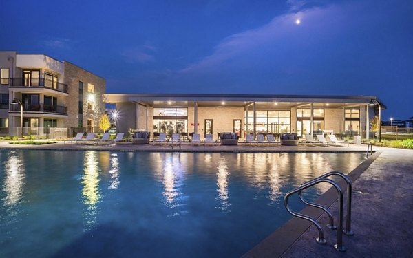 Relaxing poolside with loungers and umbrellas at The Sommery Apartments in a tranquil setting