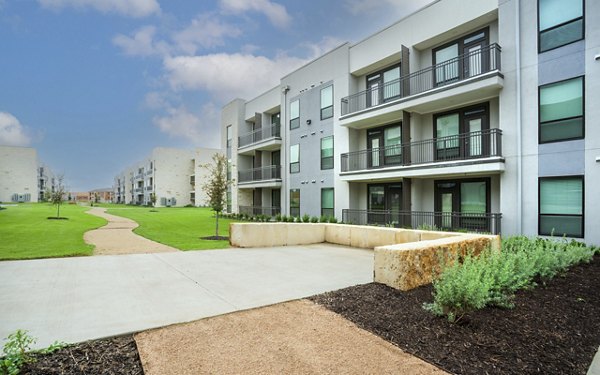 Tranquil courtyard with lush greenery at The Sommery Apartments, perfect for relaxation