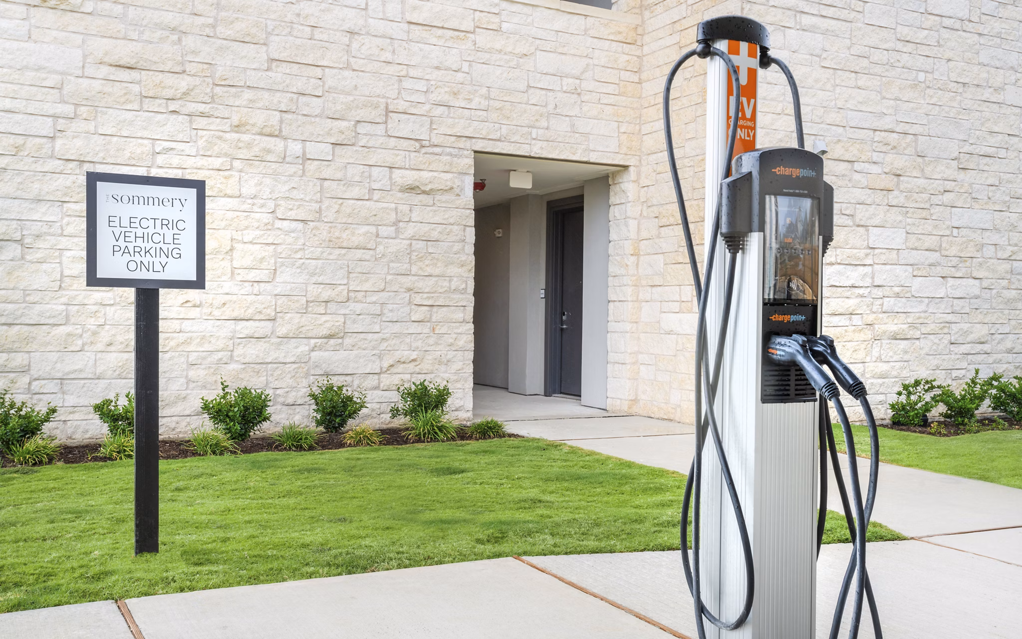 Car charging station at The Sommery Apartments, featuring modern electric vehicle amenities for eco-conscious living