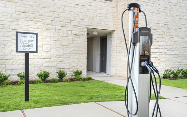 Car charging station at The Sommery Apartments, featuring modern electric vehicle amenities for eco-conscious living