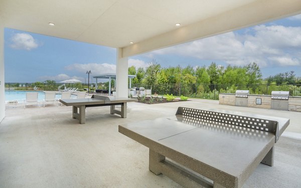 Patio with cozy seating and lush greenery at The Sommery Apartments