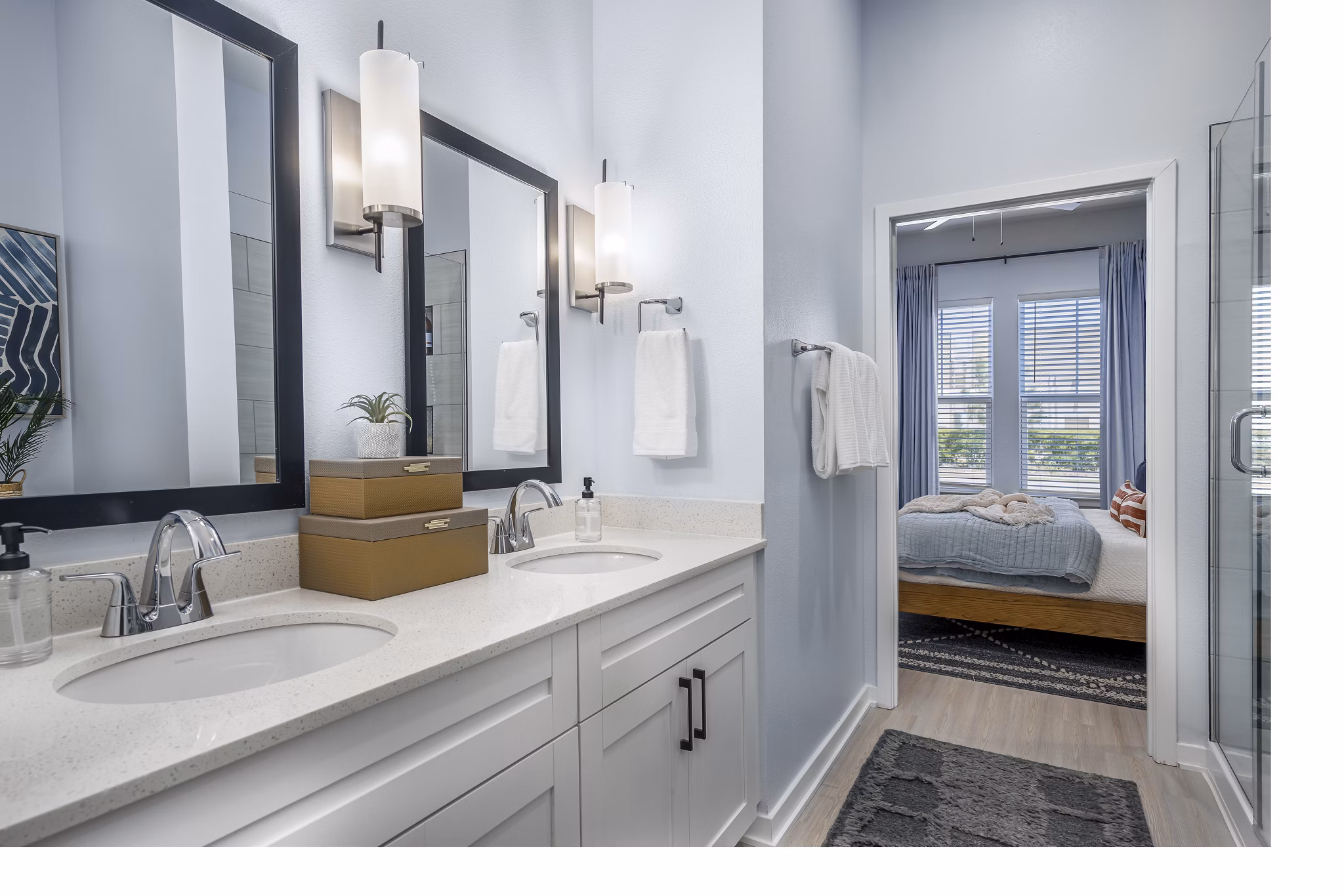 Bathroom featuring modern fixtures and a large mirror at The Elliott Apartments