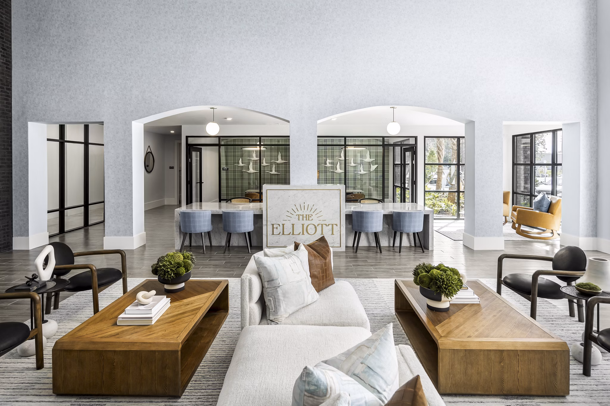 The Elliott Apartments: Modern clubhouse with stylish seating and entertainment area