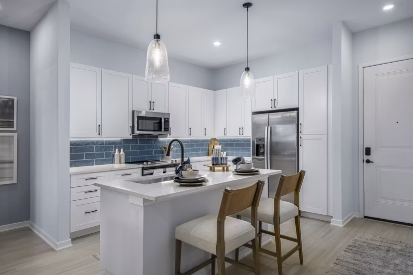 Kitchens with stainless steel appliances and quartz countertops at The Elliott Apartments luxury living