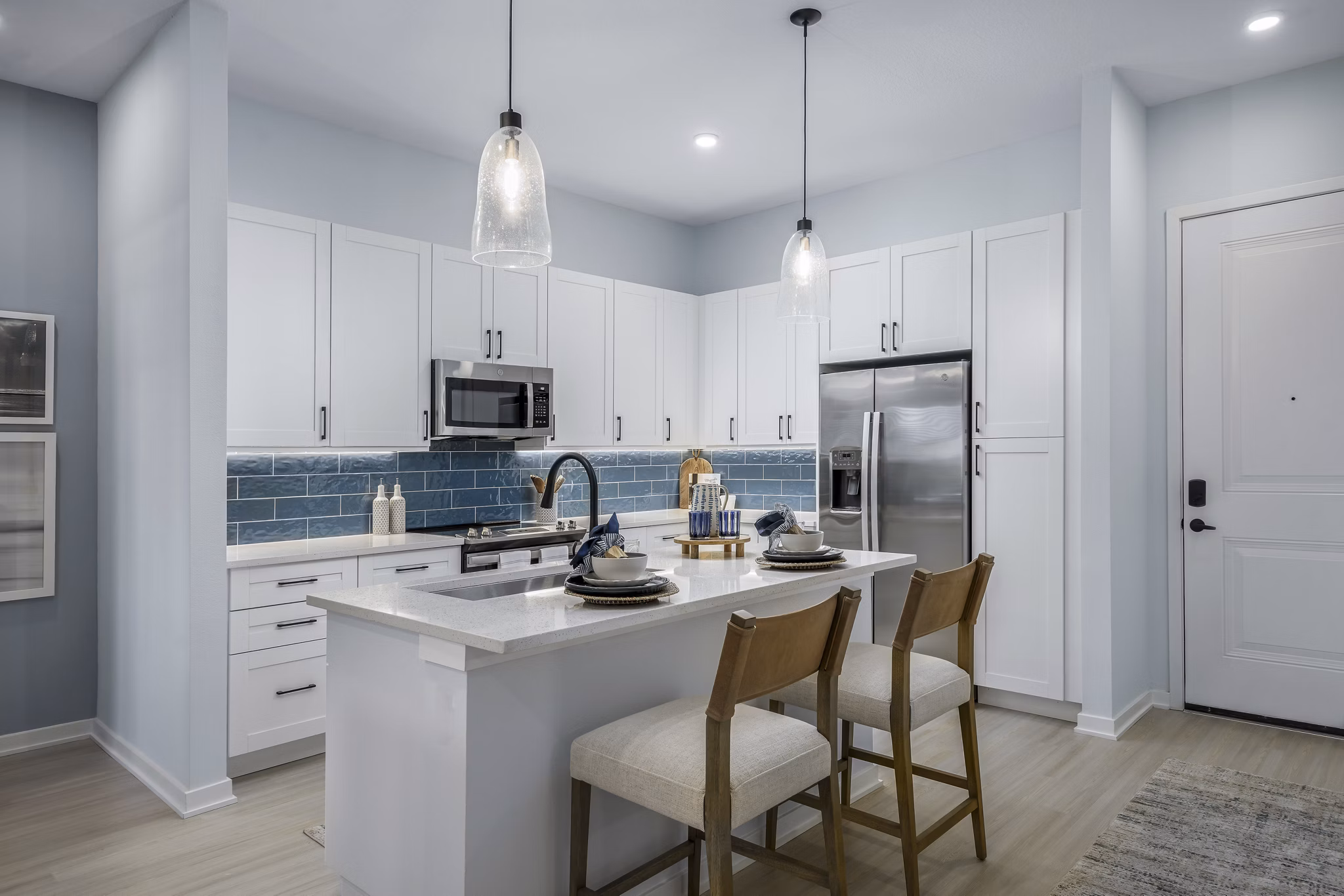 Kitchens with stainless steel appliances and quartz countertops at The Elliott Apartments luxury living