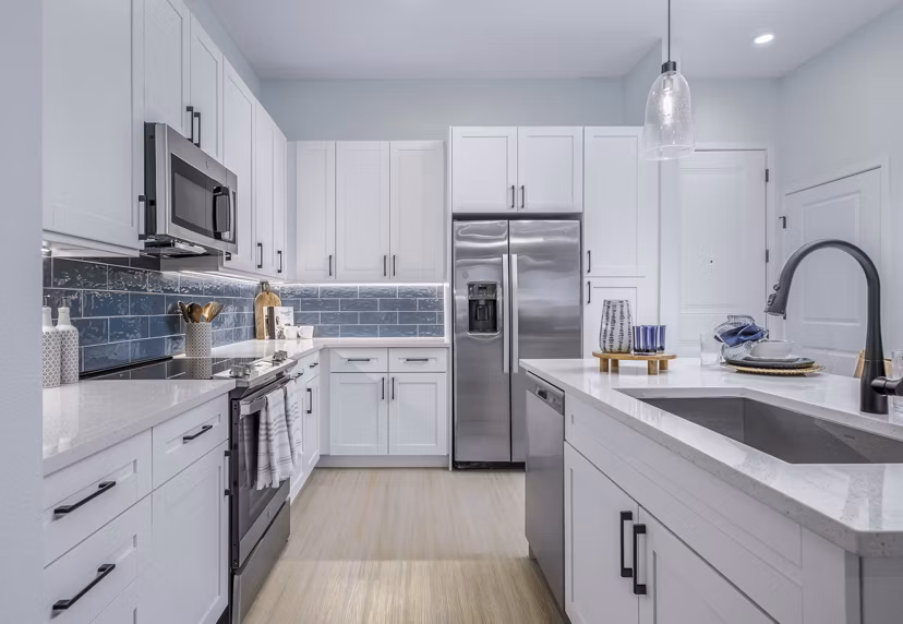 Modern kitchen with stainless steel appliances at The Elliott Apartments, featuring a sleek design and ample counter space