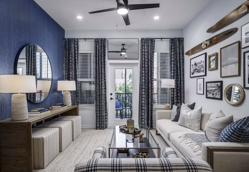 Spacious living room with modern furnishings and large windows in The Elliott Apartments