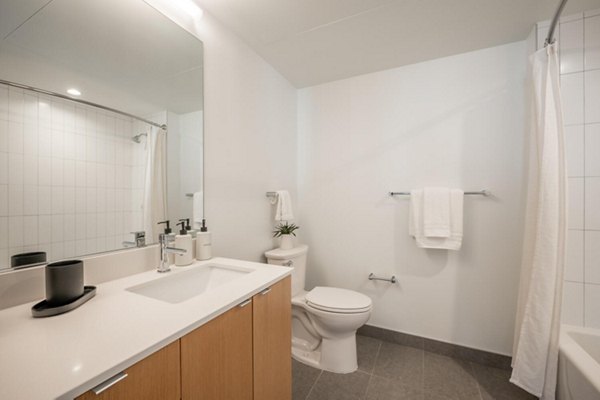 Luxury bathroom with double vanity and glass shower in Collection 14 Apartments