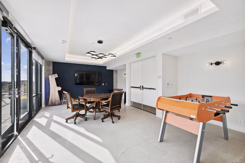 Clubhouse game room with billiards and seating area at Collection 14 Apartments