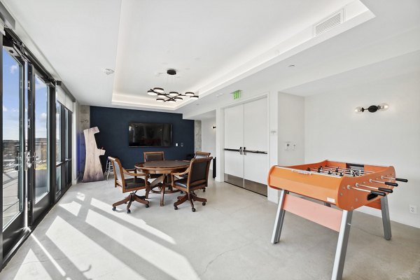 Clubhouse game room with billiards and seating area at Collection 14 Apartments