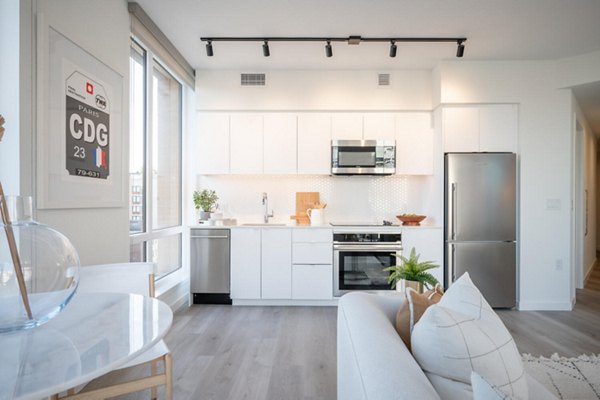 Modern kitchen with stainless steel appliances in Collection 14 Apartments