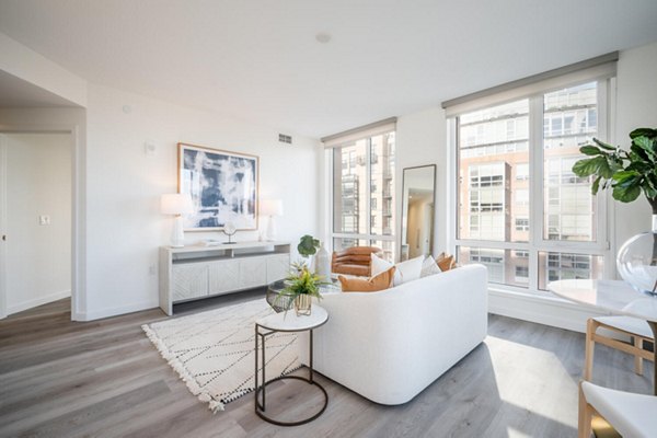 Living room featuring modern decor and natural light in Collection 14 Apartments