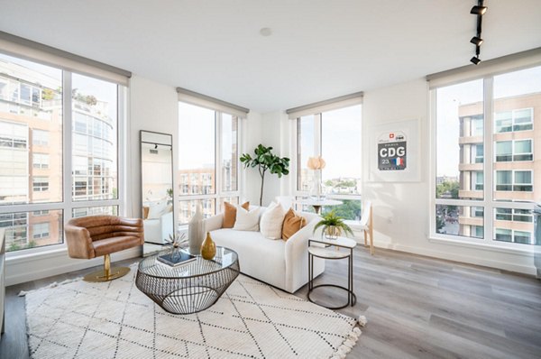 Spacious living room with modern decor in Collection 14 Apartments, featuring sleek furniture and natural light