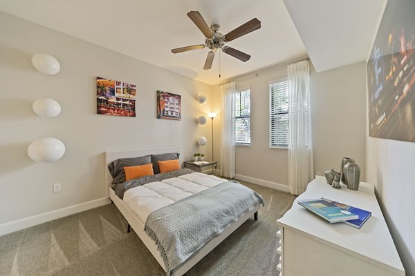 Cozy bedroom with modern furnishings in Ventura Pointe Apartments