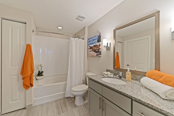 Bathroom featuring modern fixtures and marble countertops at Ventura Pointe Apartments
