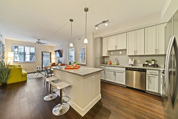 Kitchen featuring modern appliances and granite countertops in Ventura Pointe Apartments