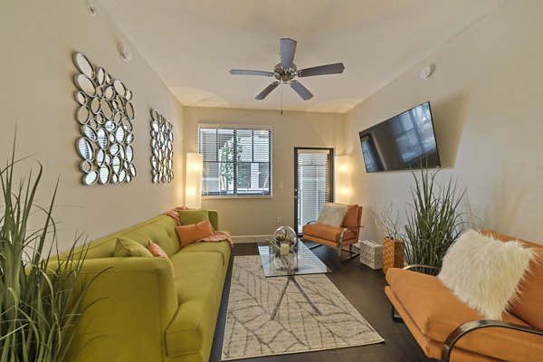 Spacious living room with modern furnishings in Ventura Pointe Apartments
