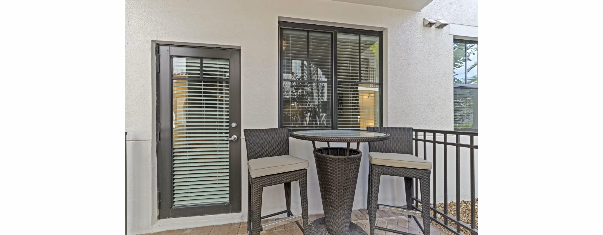 Outdoor patio at Ventura Pointe Apartments with modern seating and lush landscaping