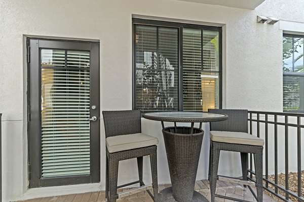 Outdoor patio at Ventura Pointe Apartments with modern seating and lush landscaping