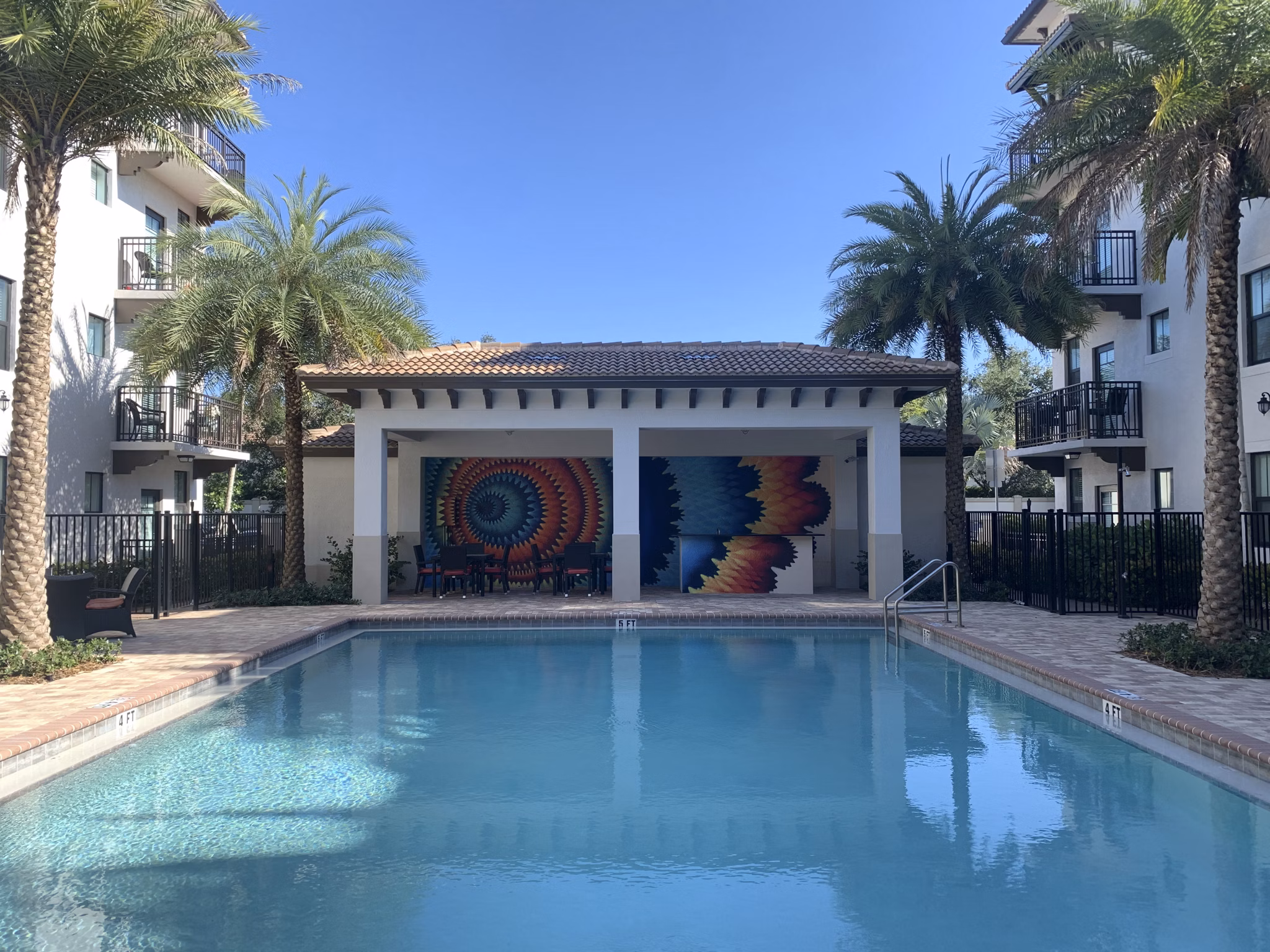 Resort-style pool with lounge chairs at Ventura Pointe Apartments in Plantation, Florida