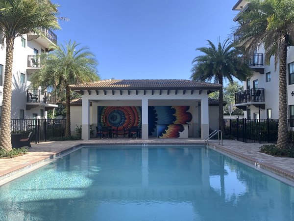 Resort-style pool with lounge chairs at Ventura Pointe Apartments in Plantation, Florida
