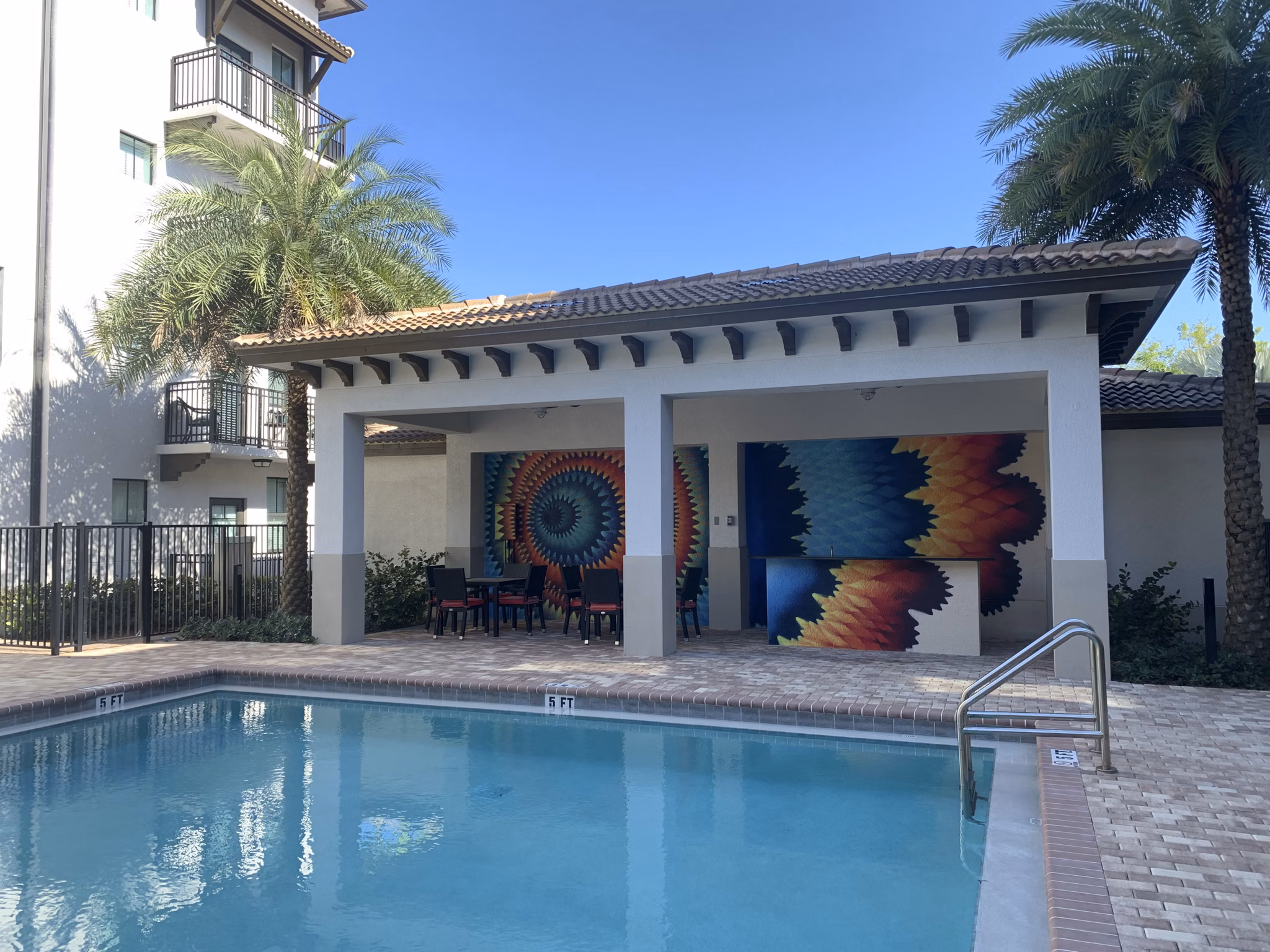 Resort-style pool with lounging areas at Ventura Pointe Apartments, offering relaxation and luxury living