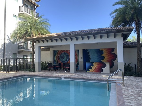 Resort-style pool with lounging areas at Ventura Pointe Apartments, offering relaxation and luxury living