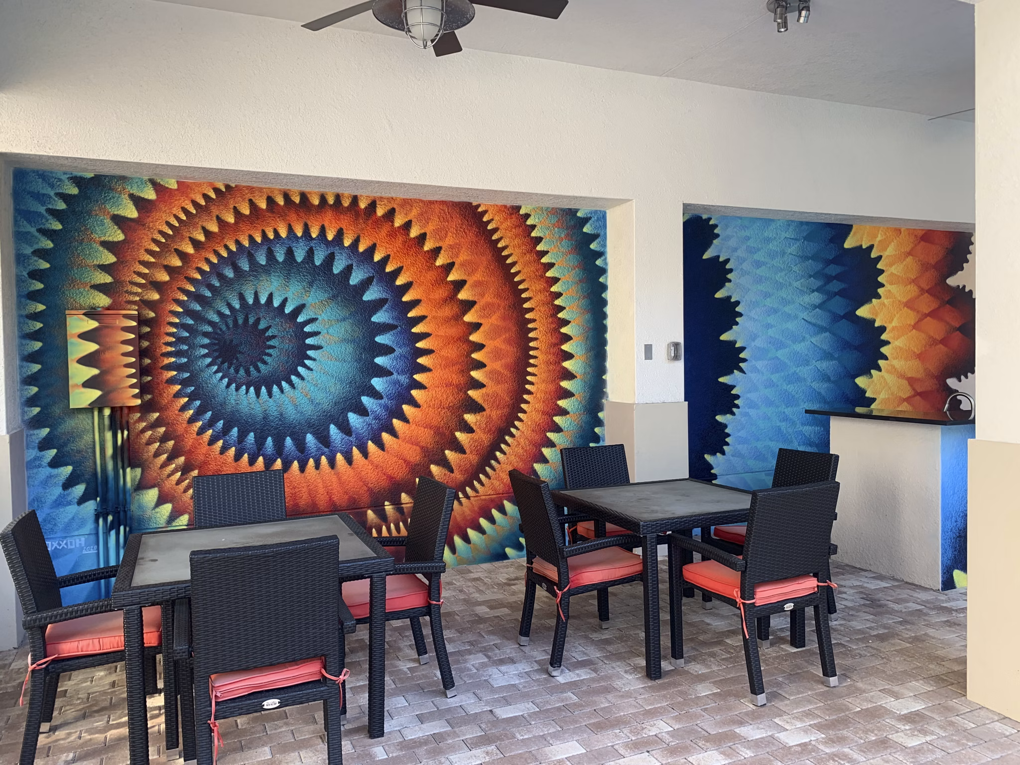 Open-air patio with cozy seating at Ventura Pointe Apartments, perfect for relaxing and socializing in a vibrant community setting