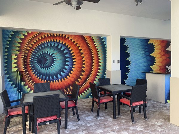 Open-air patio with cozy seating at Ventura Pointe Apartments, perfect for relaxing and socializing in a vibrant community setting