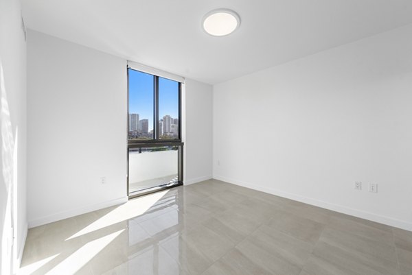 Bedroom featuring modern decor and plush bedding at The Vibe Miami Apartments