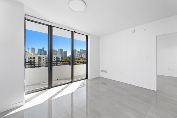 Bedroom with modern decor and natural light at The Vibe Miami Apartments