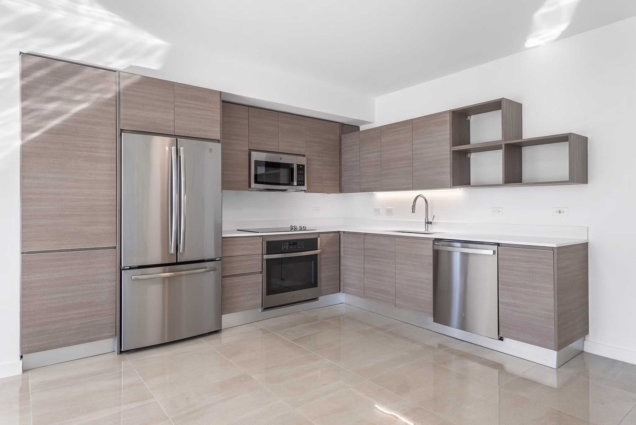 Modern kitchen with stainless steel appliances and island at The Vibe Miami Apartments