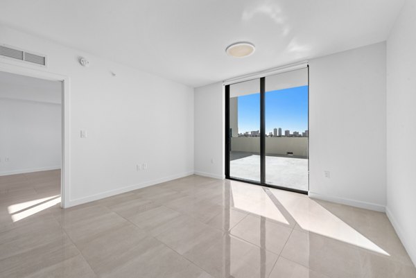 Living room featuring modern furnishings and airy design at The Vibe Miami Apartments