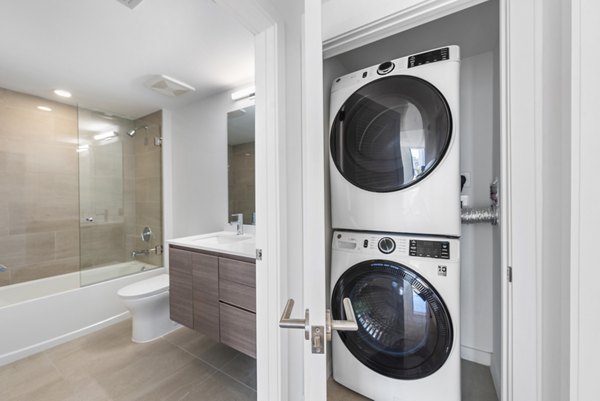 Modern laundry room with energy-efficient washers and dryers at The Vibe Miami Apartments, offering convenience and style in every detail